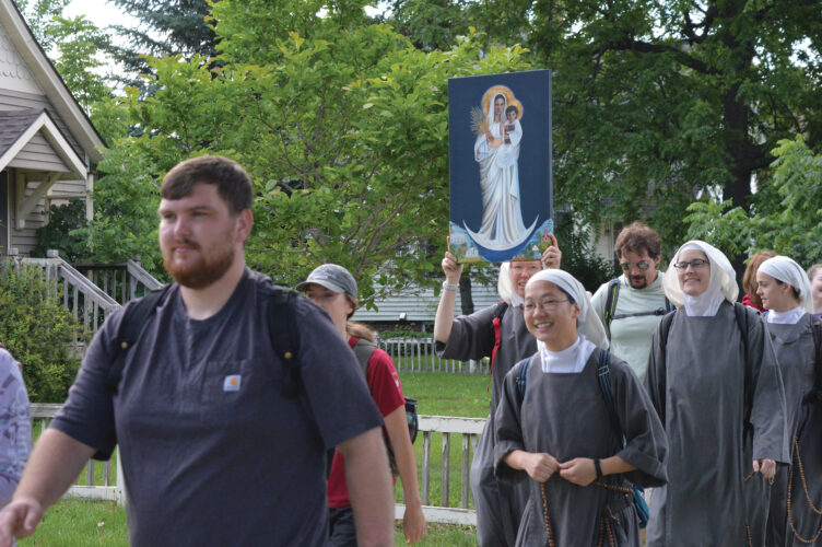 Pilgrims carry ‘Our Lady of the Prairie’ down Main